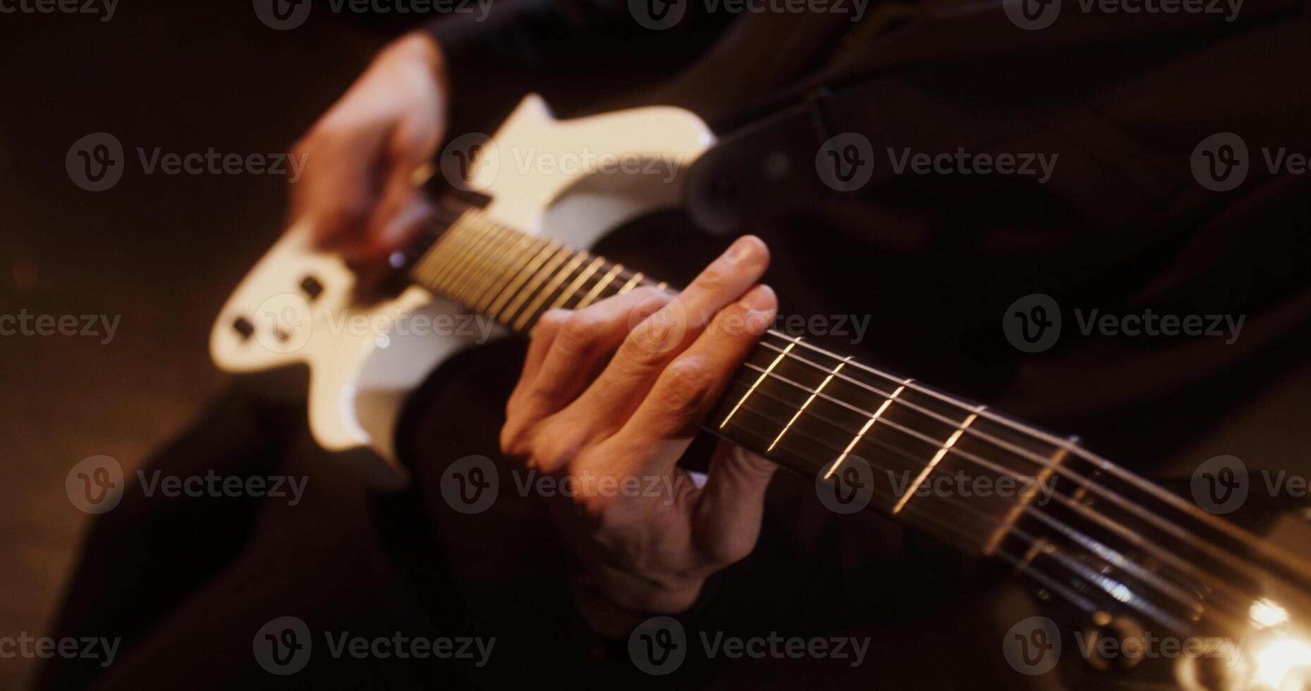 A person playing an electric guitar photo