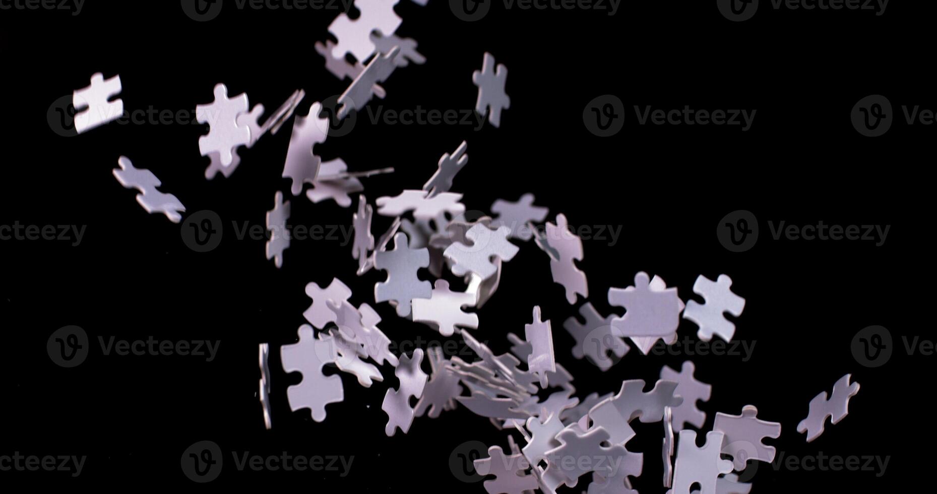 A pile of white puzzle pieces falling to the ground photo