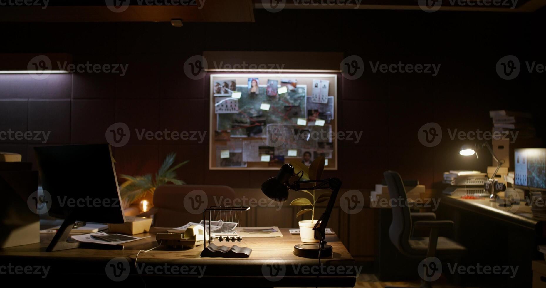 A dark room with a desk and a lamp photo