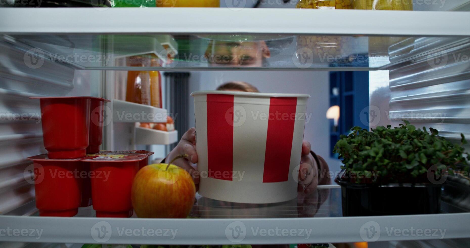 A person looking into a refrigerator photo
