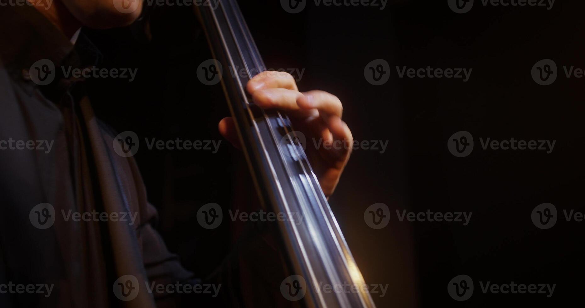 A close up of a man playing a cello photo