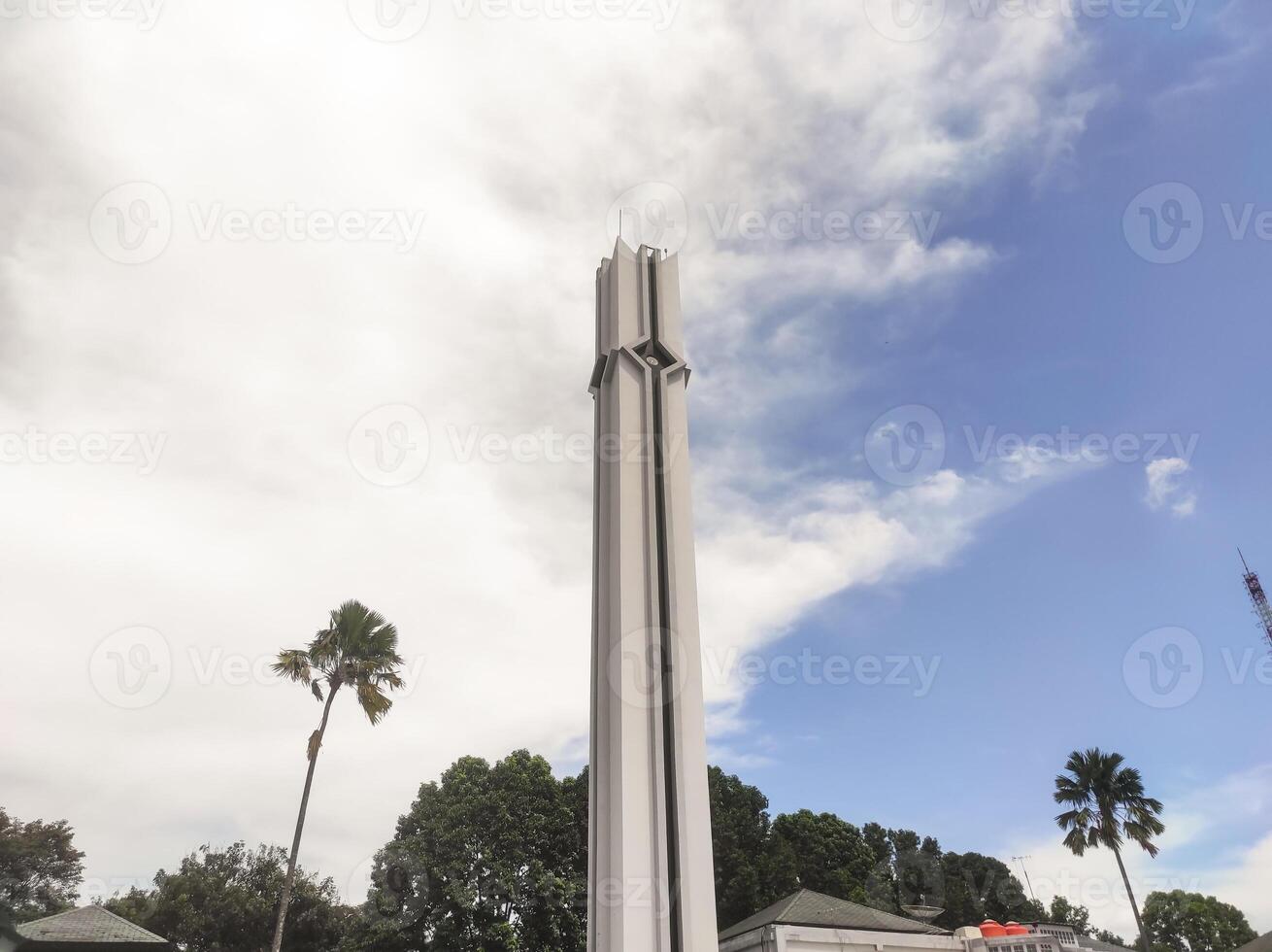 A low-angle shot of the white mosque tower. The minarets surrounding the mosque serve to broadcast the call to prayer for Muslims. Mosque architecture with copy space. photo