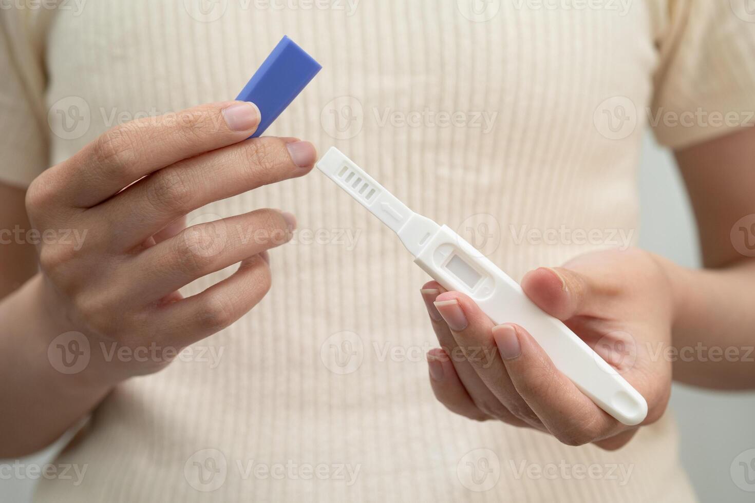 Asian holding pregnancy test for female of ovulation day, fetus, maternity, childbirth birth control. photo