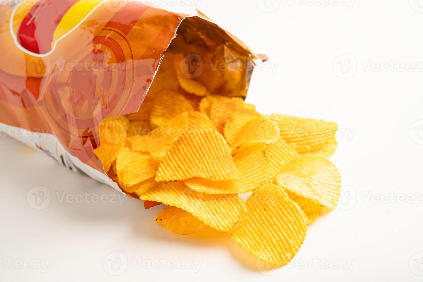 Potato chips deep fried snack fast food in open bag. photo