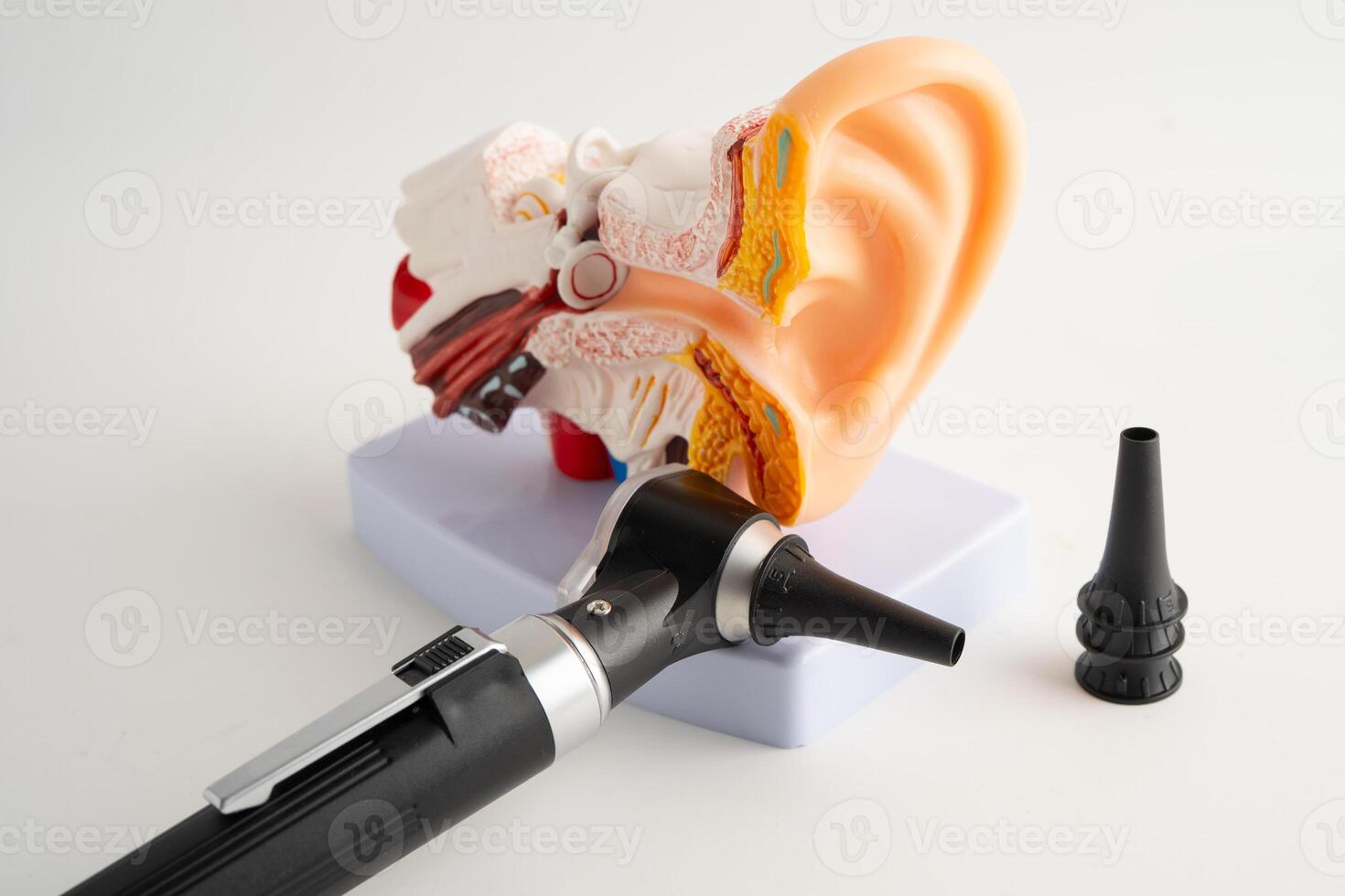 Otoscope audiologist or ENT doctor use otoscope checking ear and treat hearing loss problem. photo