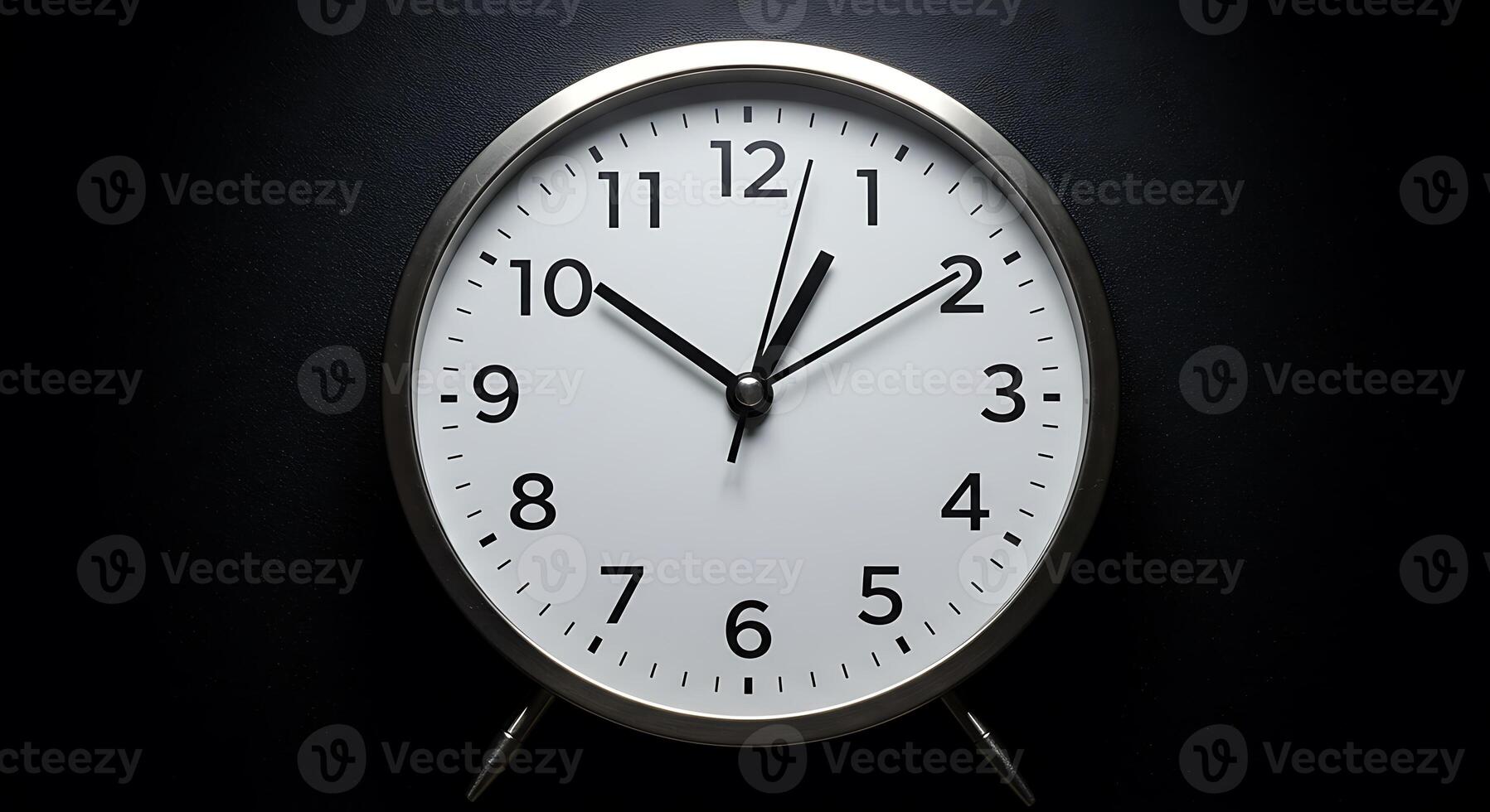 A clock is shown on a black background photo