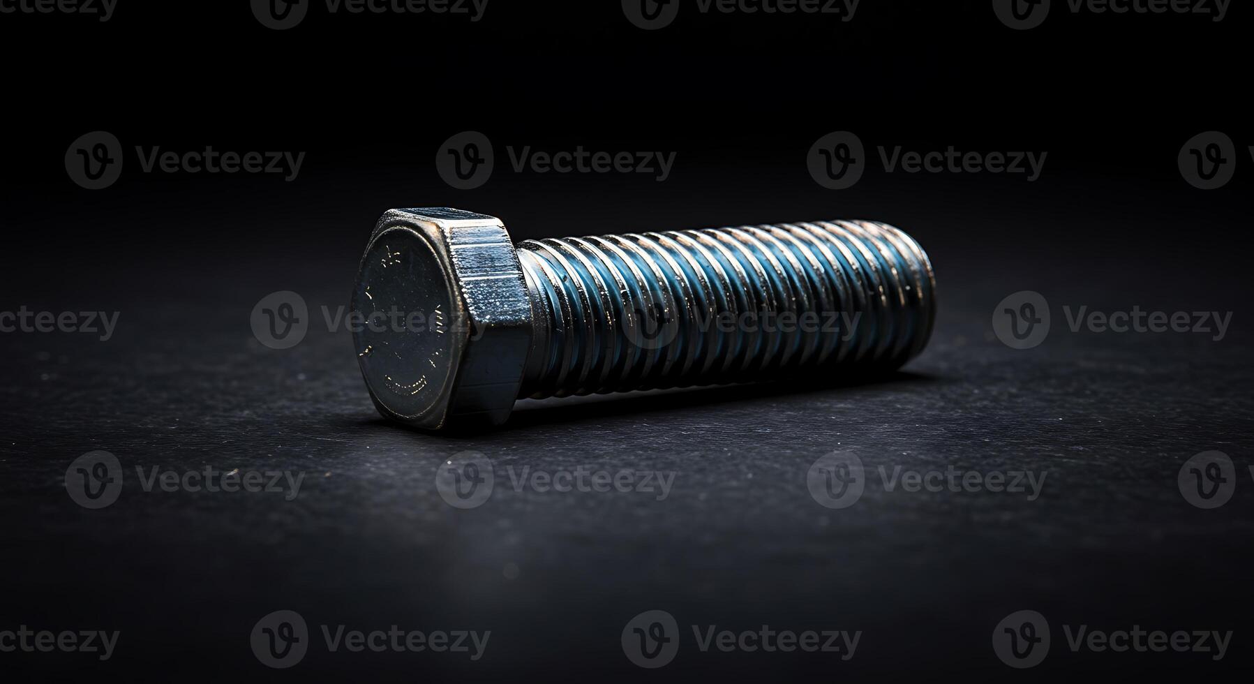 A screw on a black surface photo