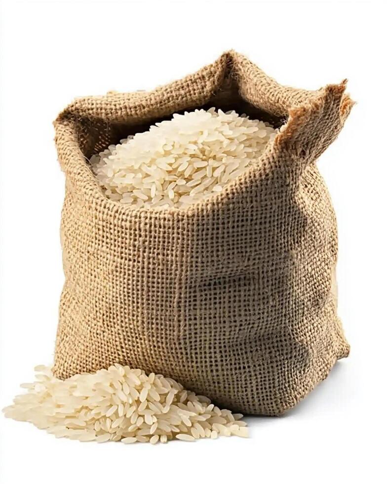 A close up shot of a burlap sack filled with white rice spilling onto a white background photo
