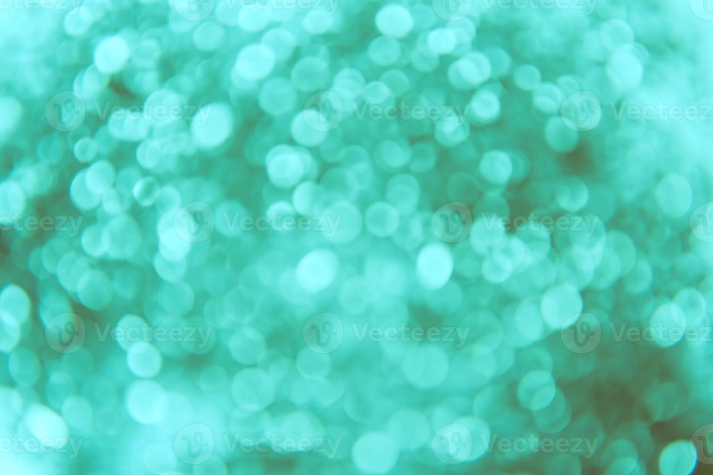 A blurry image of a green background with a lot of lights photo