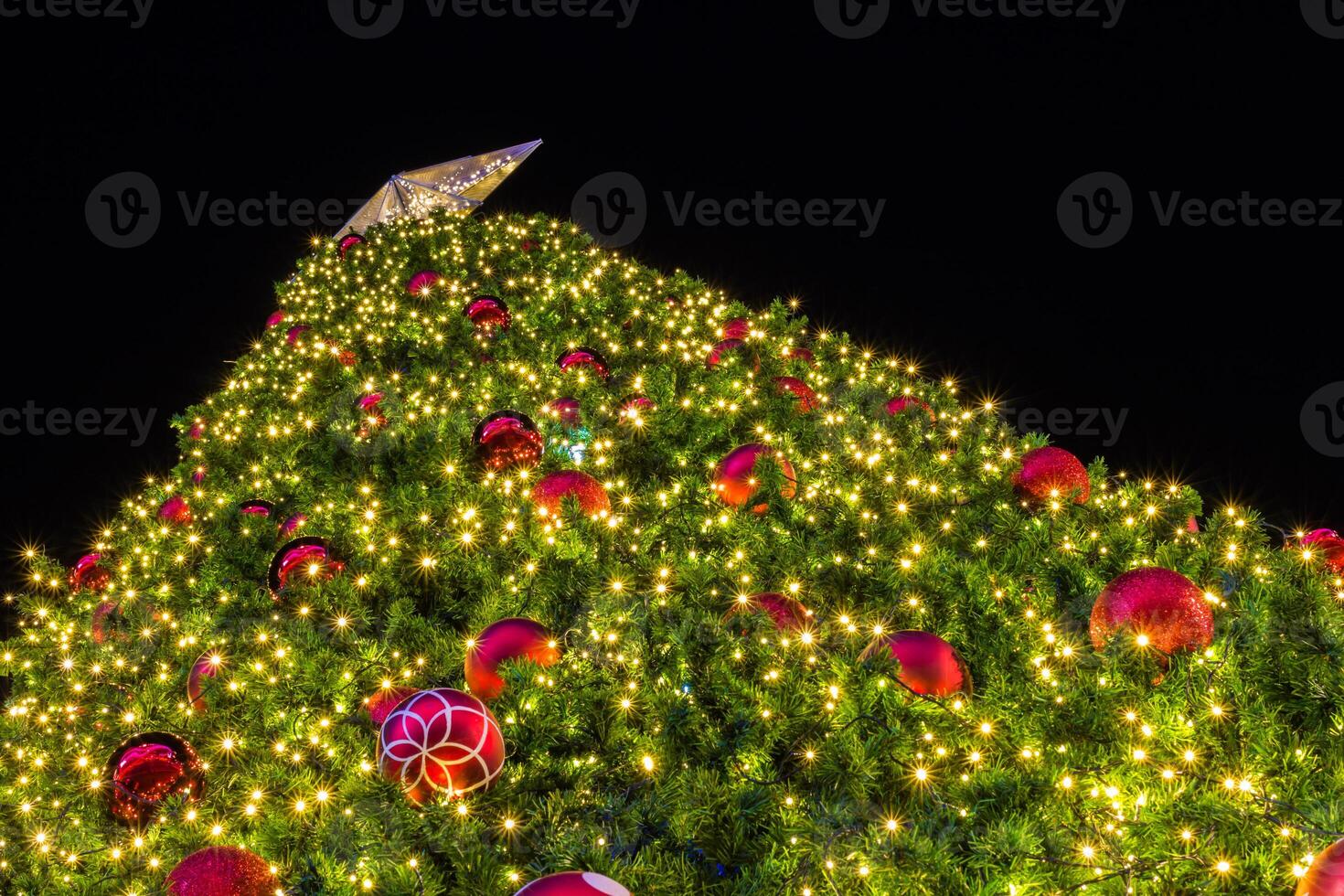 A large christmas tree with red and green decorations photo