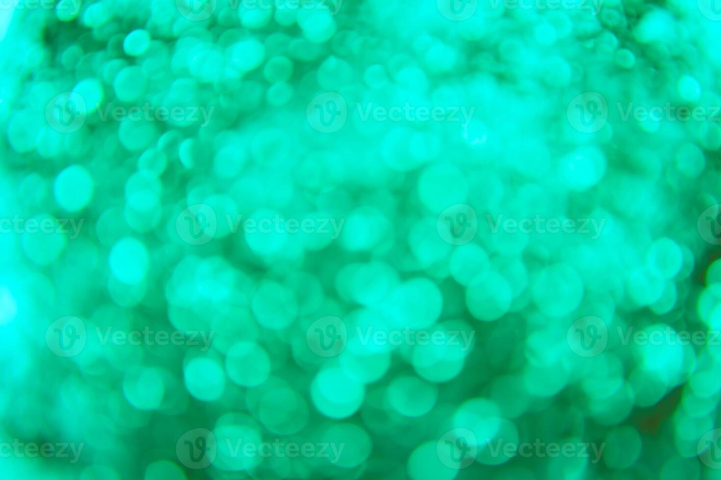 A green light is shining on a green background photo