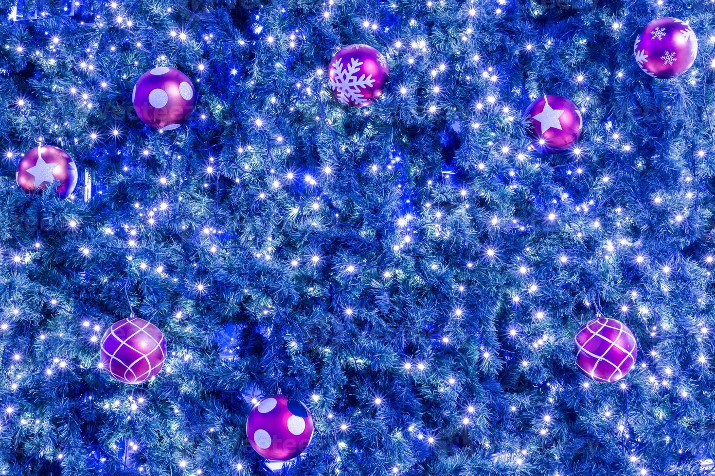 A christmas tree with many balls and lights photo