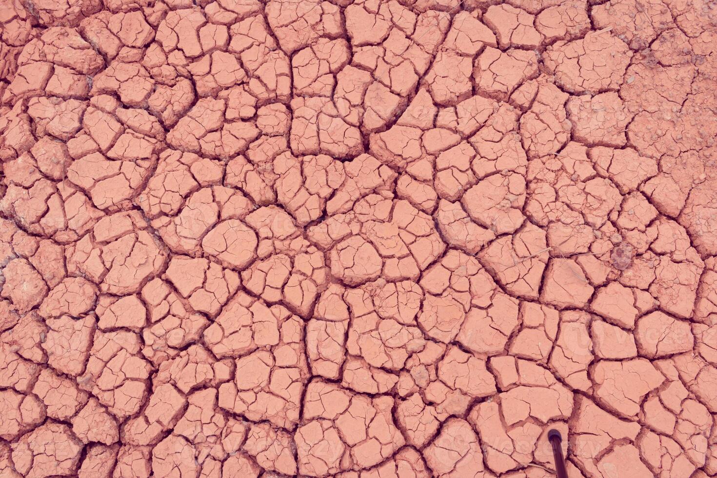 A close up of a cracked surface with a red background photo