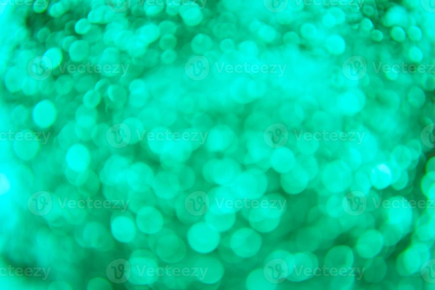 A green and blue background with a blurry image of a green ball photo