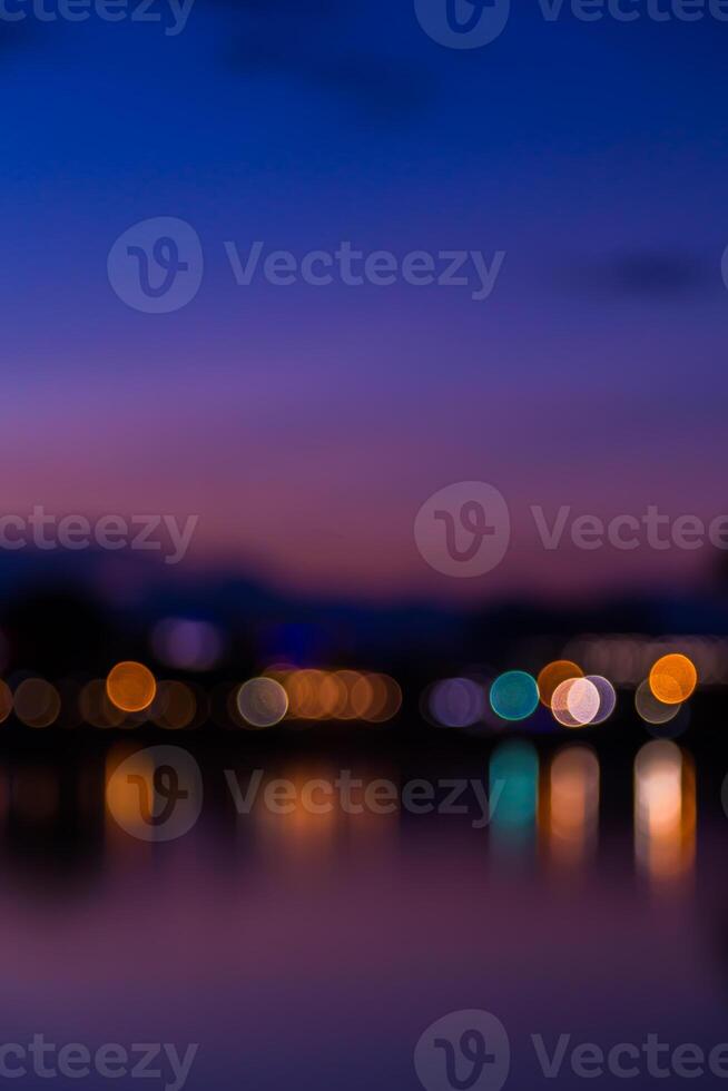 Blurred bokeh light background of the city at night photo