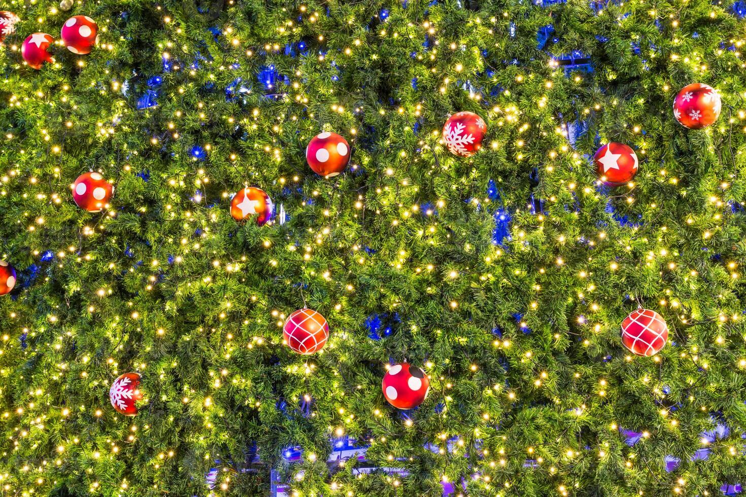 A large tree with many christmas balls hanging from it photo