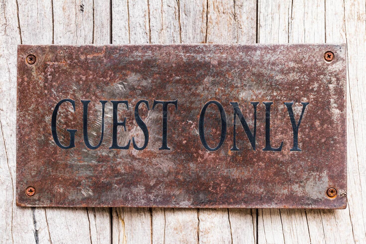 A sign that says guest only on a wooden wall photo