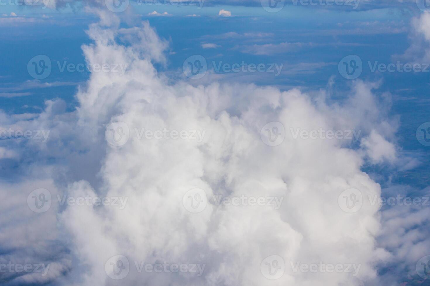 A view of a plane flying through a cloud filled sky photo