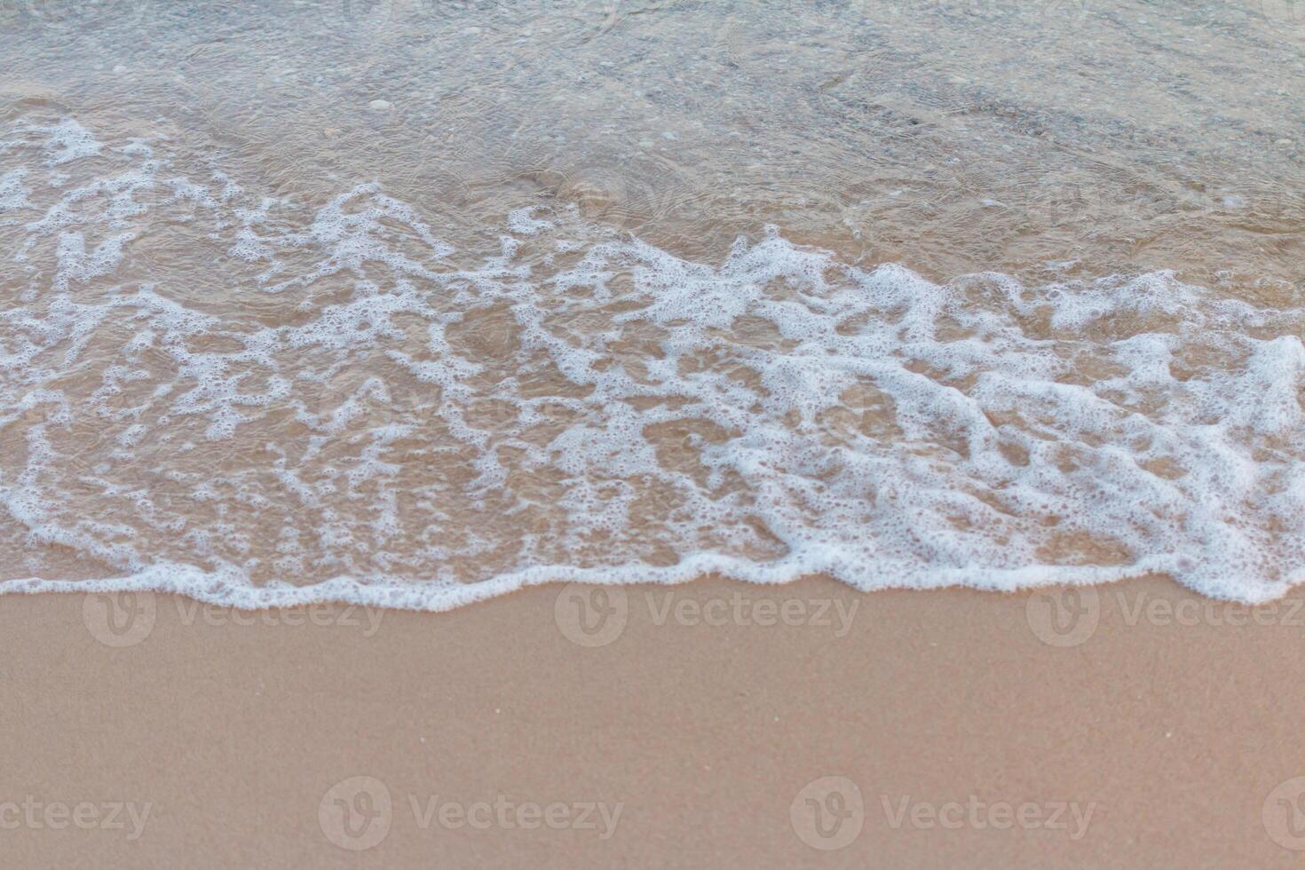 A wave is coming in to the shore photo