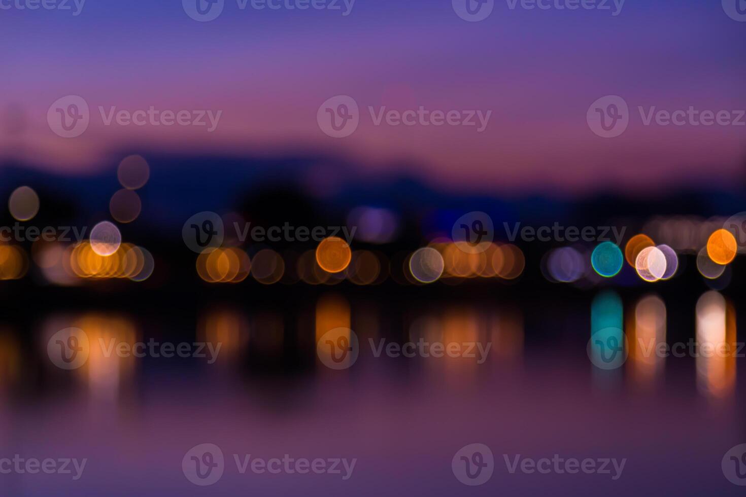 A blurry photo of lights on the water at night