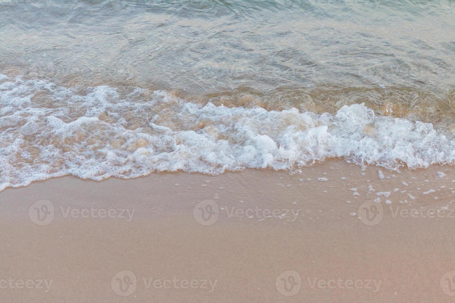 A person walking on the beach with a surfboard photo