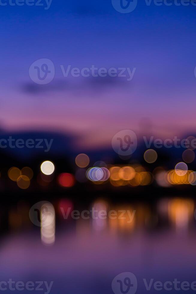 Blurred background of lights at night over water photo