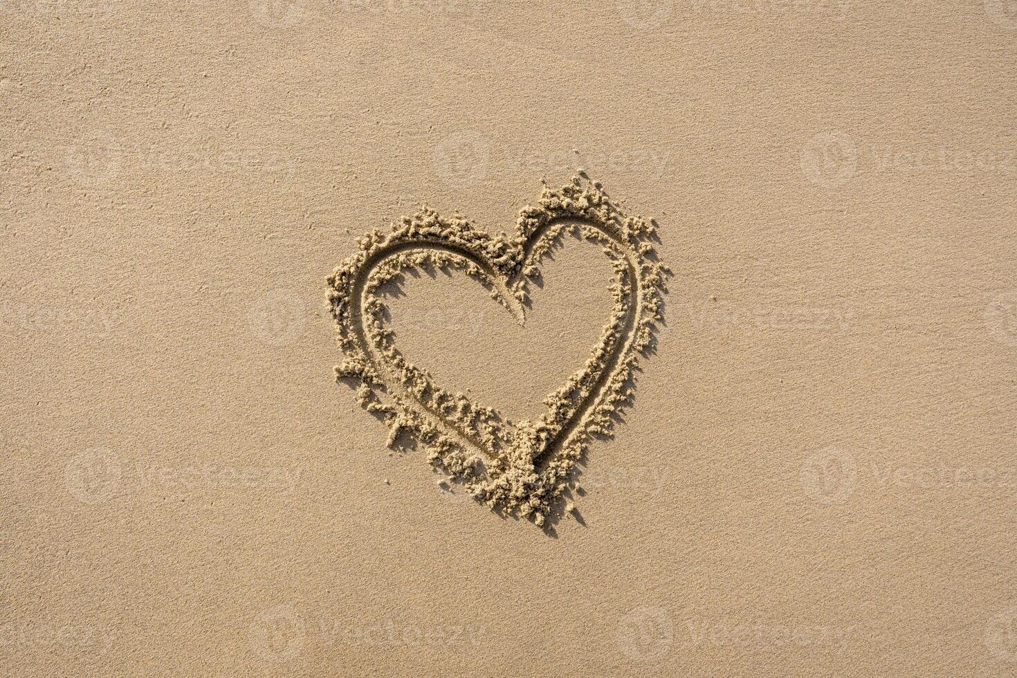 Heart on Textured Beach Sand Background photo