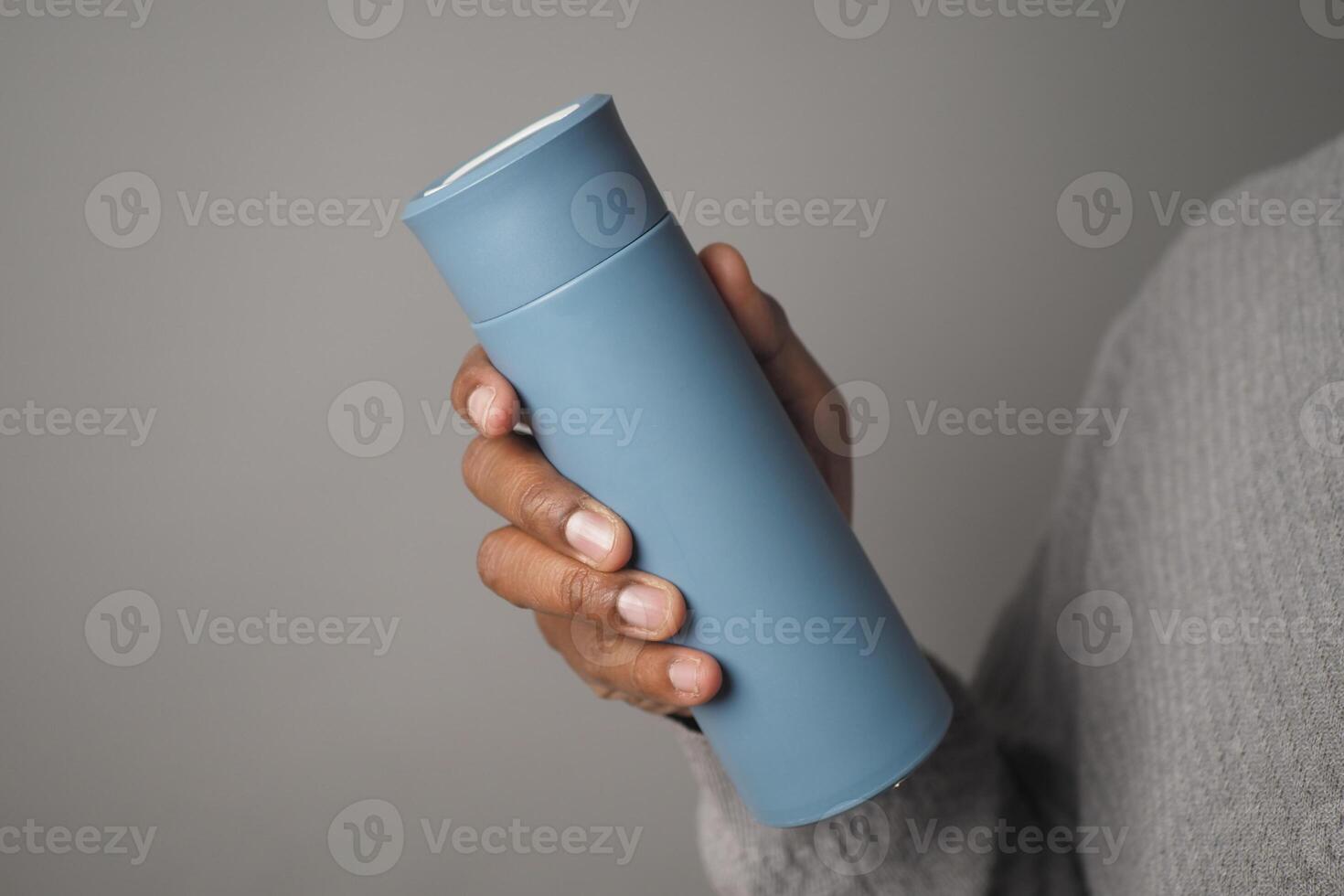 Reusable Water Bottle held in a person hand indoors photo