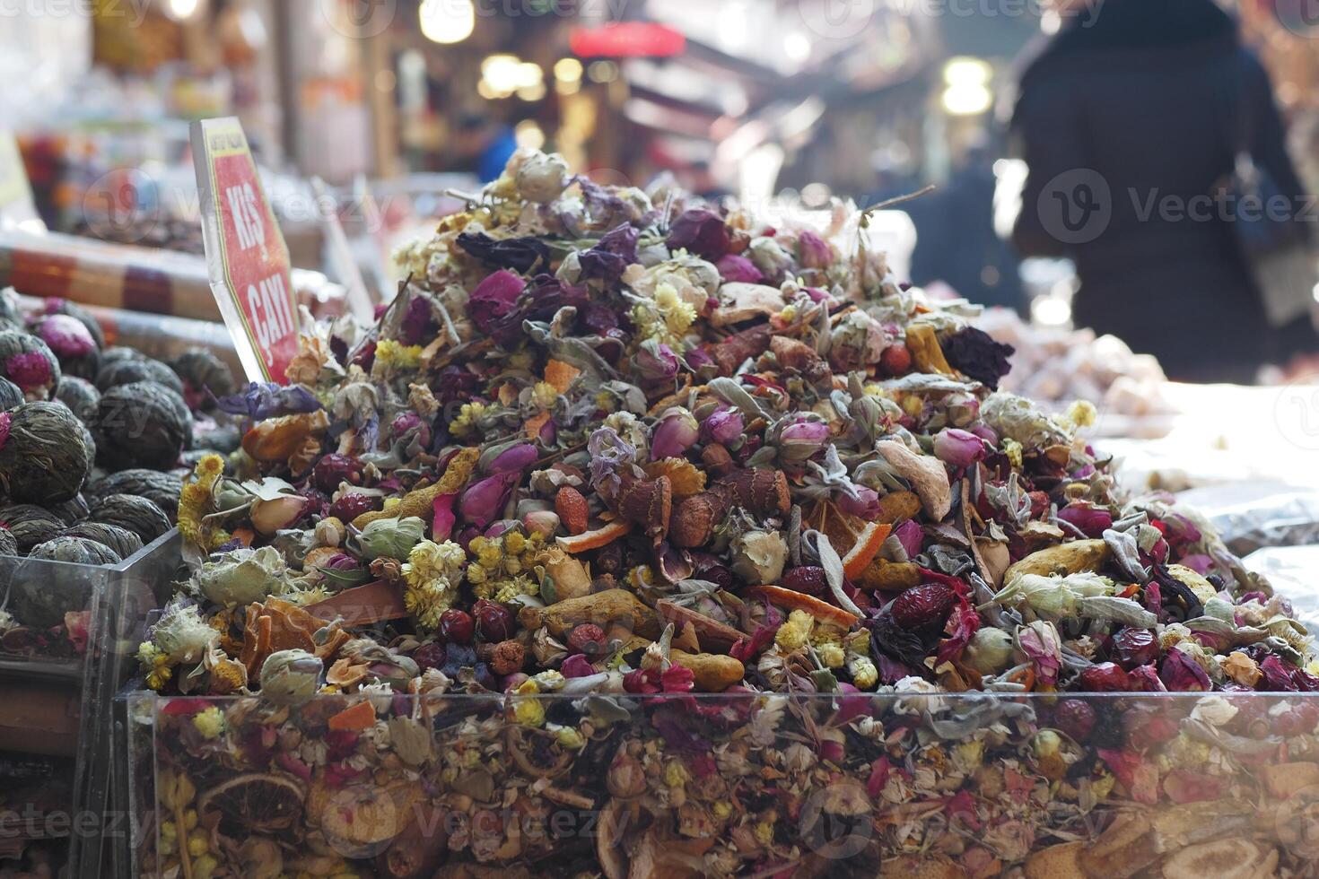 Colorful pile of dried flowers at a bustling market photo