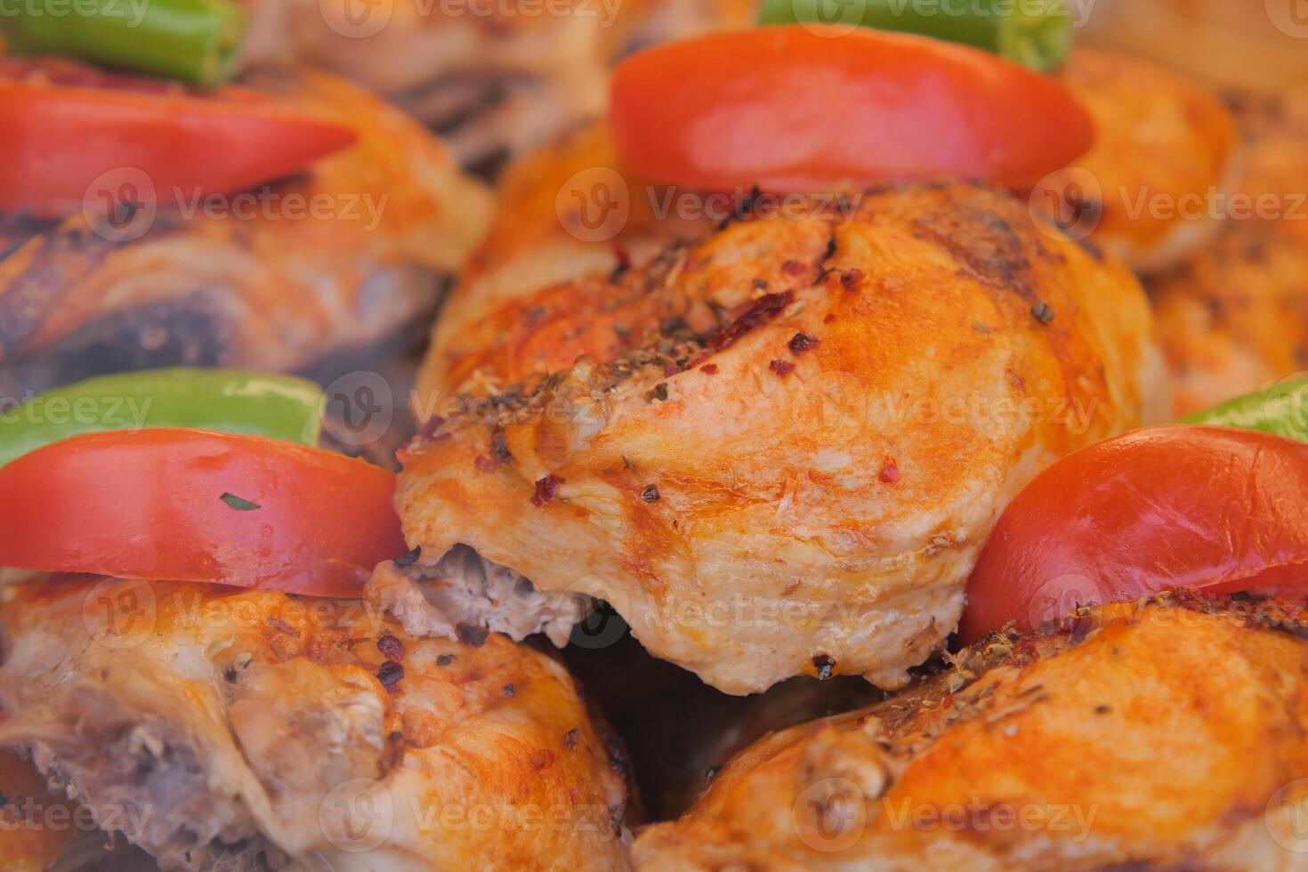 Delicious grilled chicken with fresh vegetables on display photo