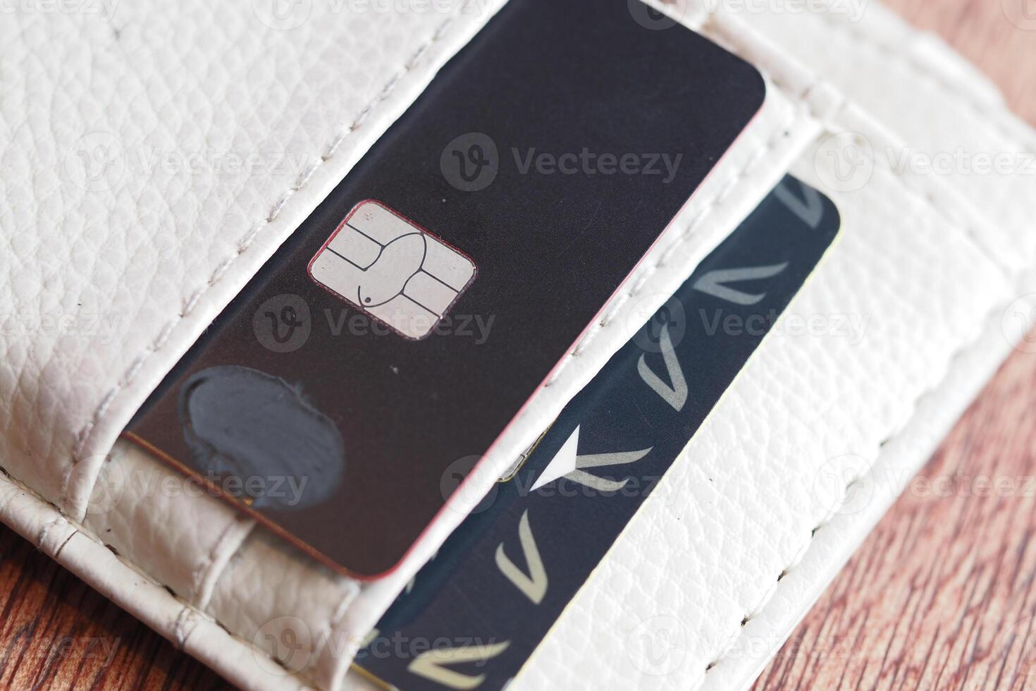 Credit card and SIM card in a wallet on wooden table photo