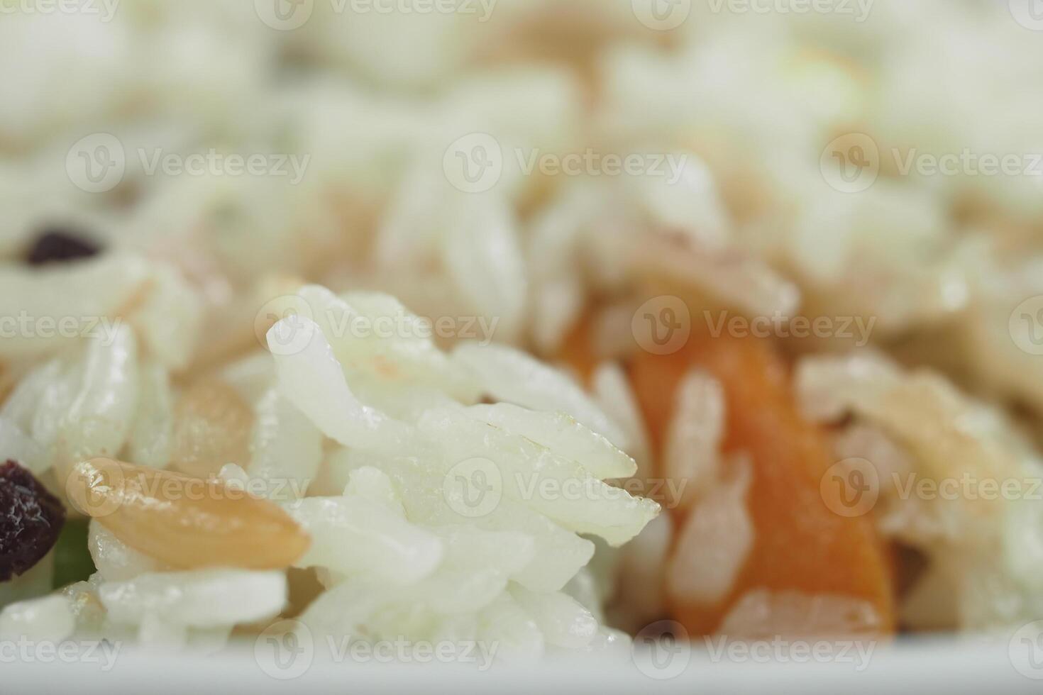Colorful rice dish with vegetables and nuts close up photo