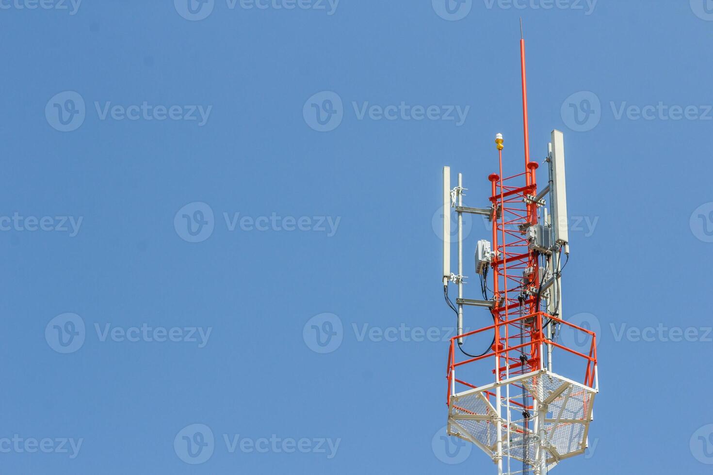 A tower with a cell phone tower and a cell phone antenna photo