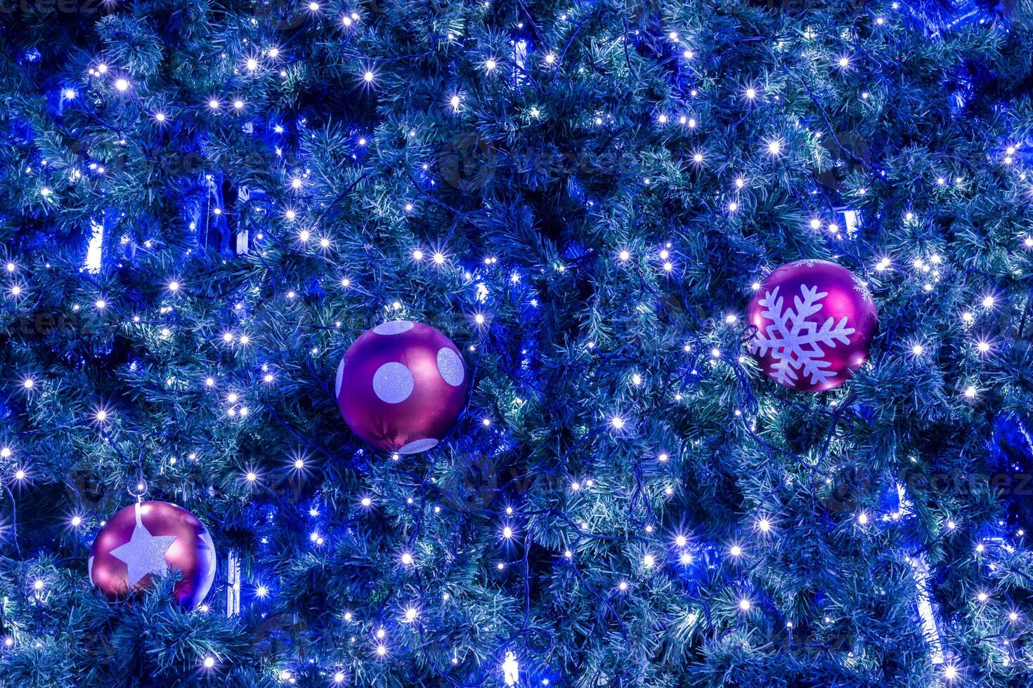 A christmas tree with blue lights and ornaments photo