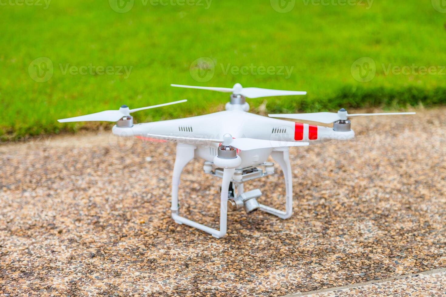 A small white drone on the ground photo