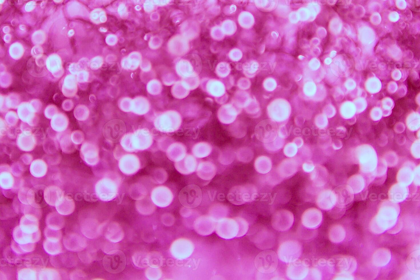 A pink background with many small bubbles photo
