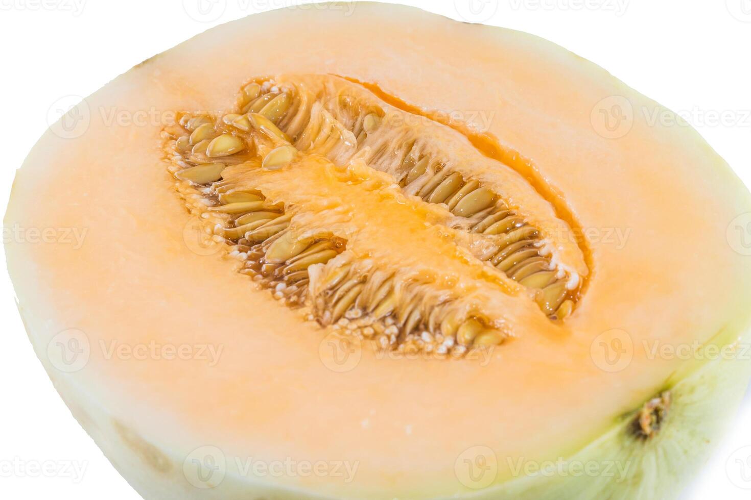 A melon cut in half on a white background photo