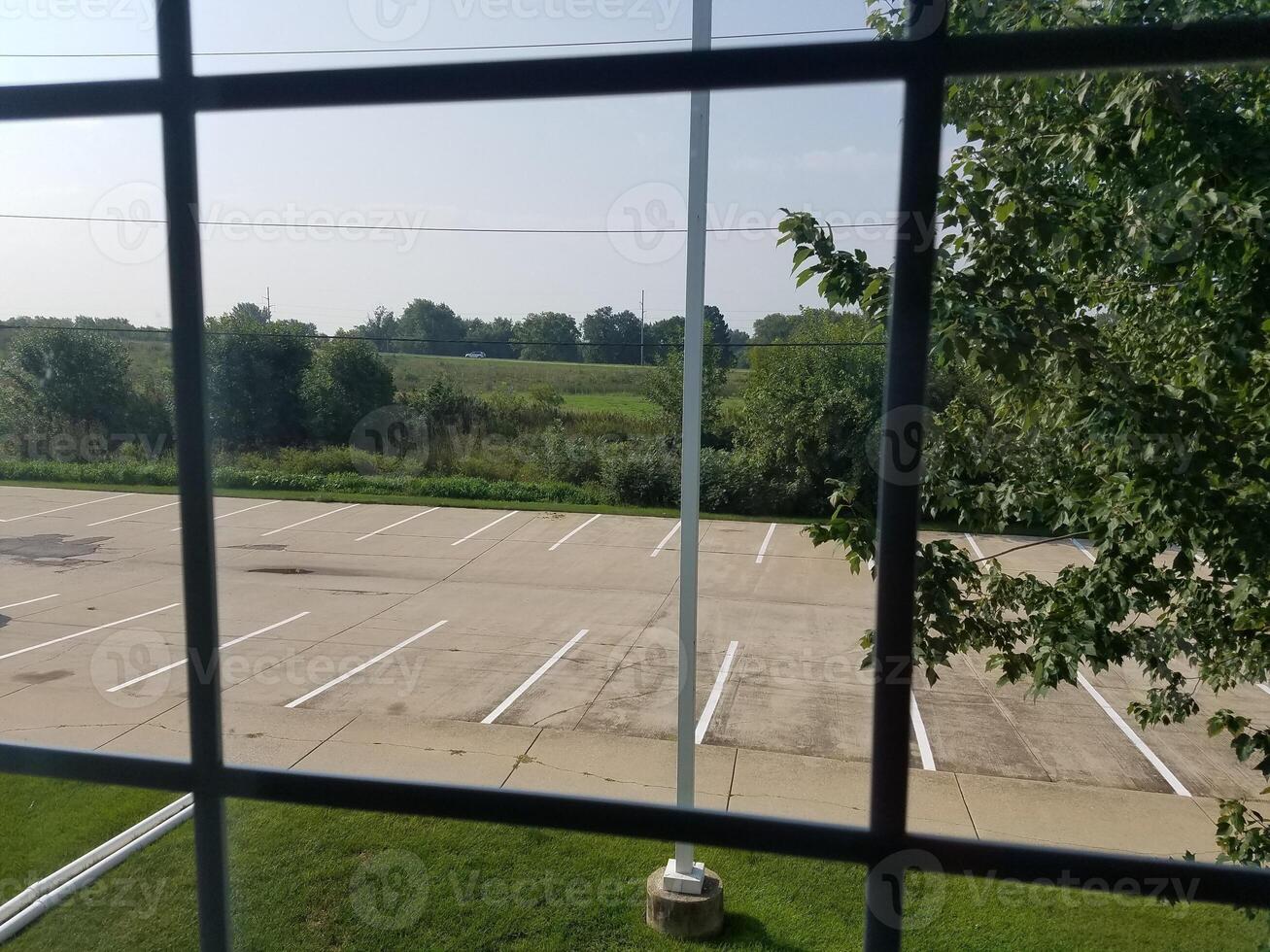 Looking Out a Hotel Window at an Empty Parking Lot in Springfield, Illinois photo