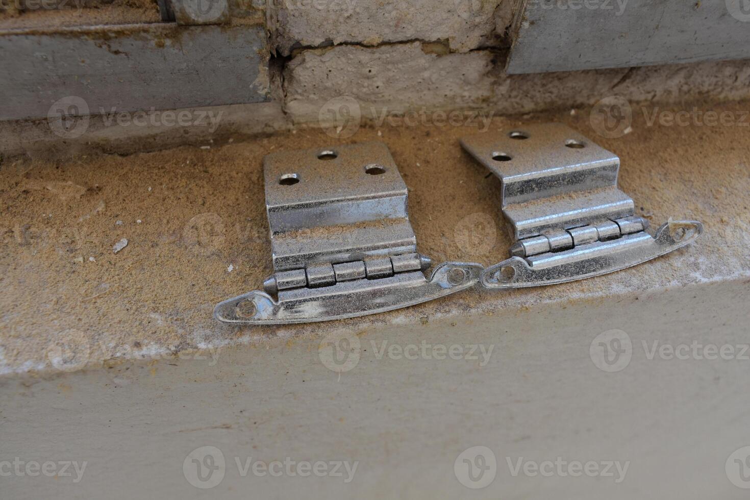 Silver Hinges Sitting on a Dirty Windowsill Ledge, Home Improvement Construction photo