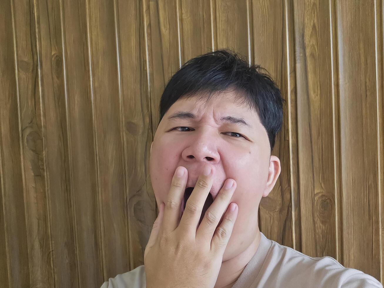The young man yawning because was so sleepy photo