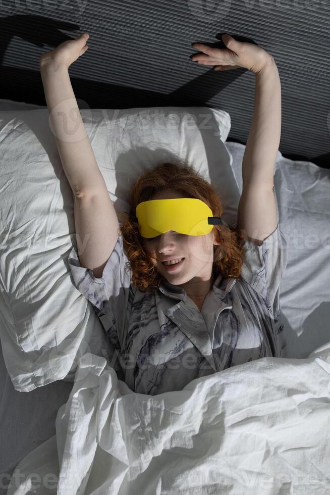 Gently Awakening in Bed with an Eye Mask and a Relaxed, Blissful Expression on My Face photo