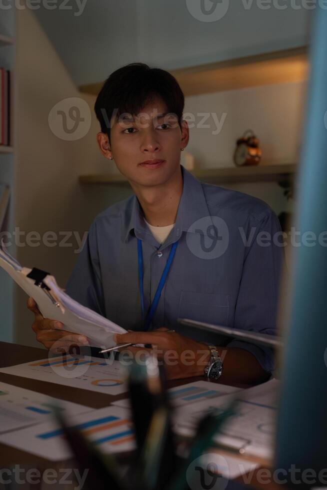 Young professional focused on work in a modern office environment photo