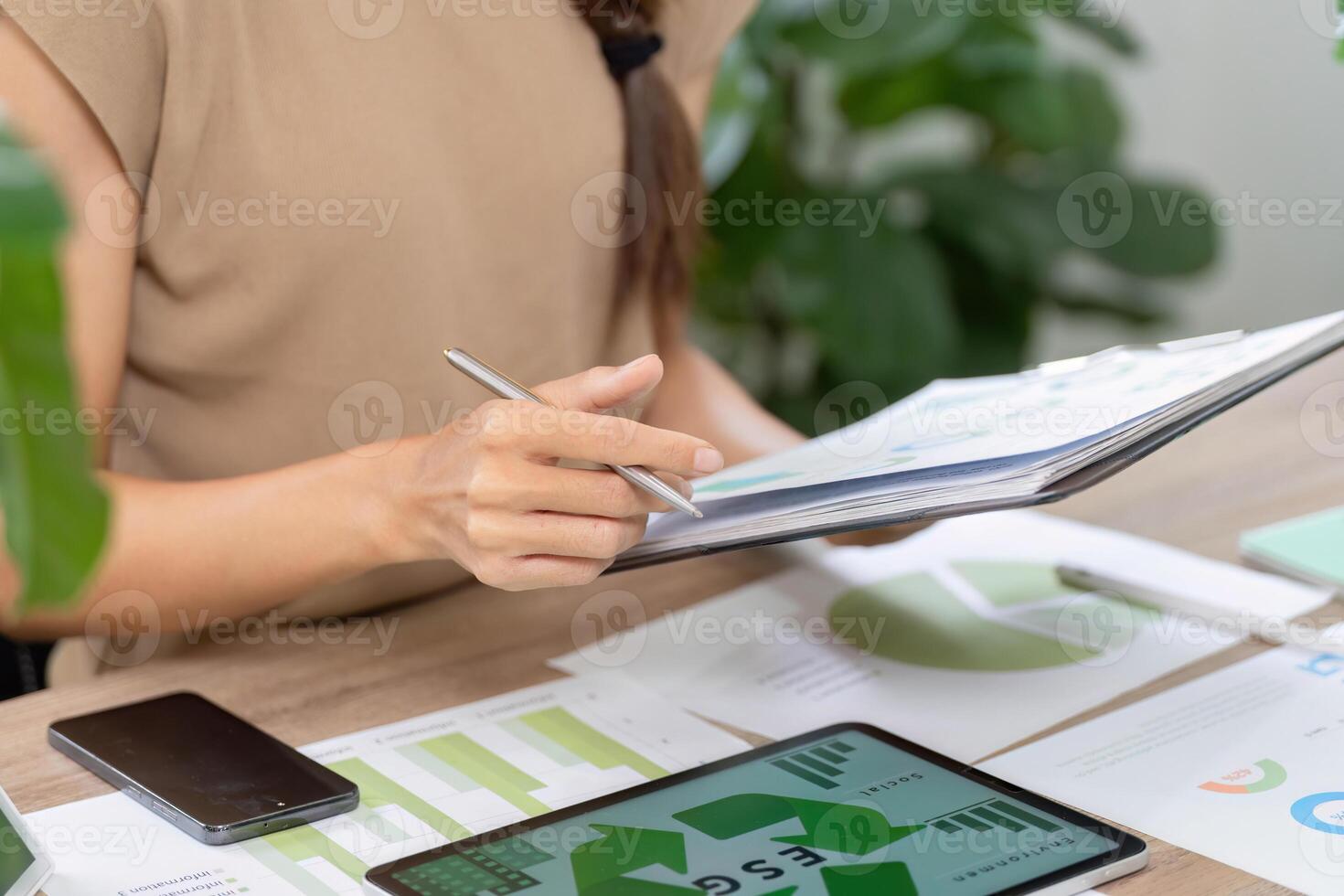 Sustainability focus. Evaluating ESG reports and data on a desk photo