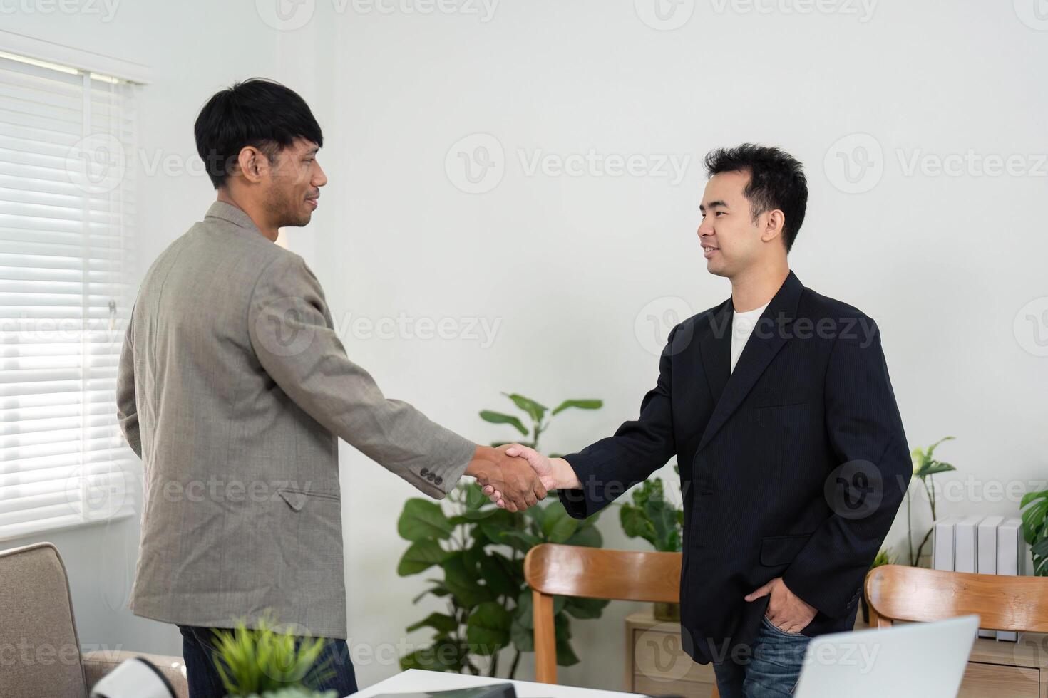 Business Agreement and Professionalism. Two colleagues shaking hands to finalize a successful business deal. photo