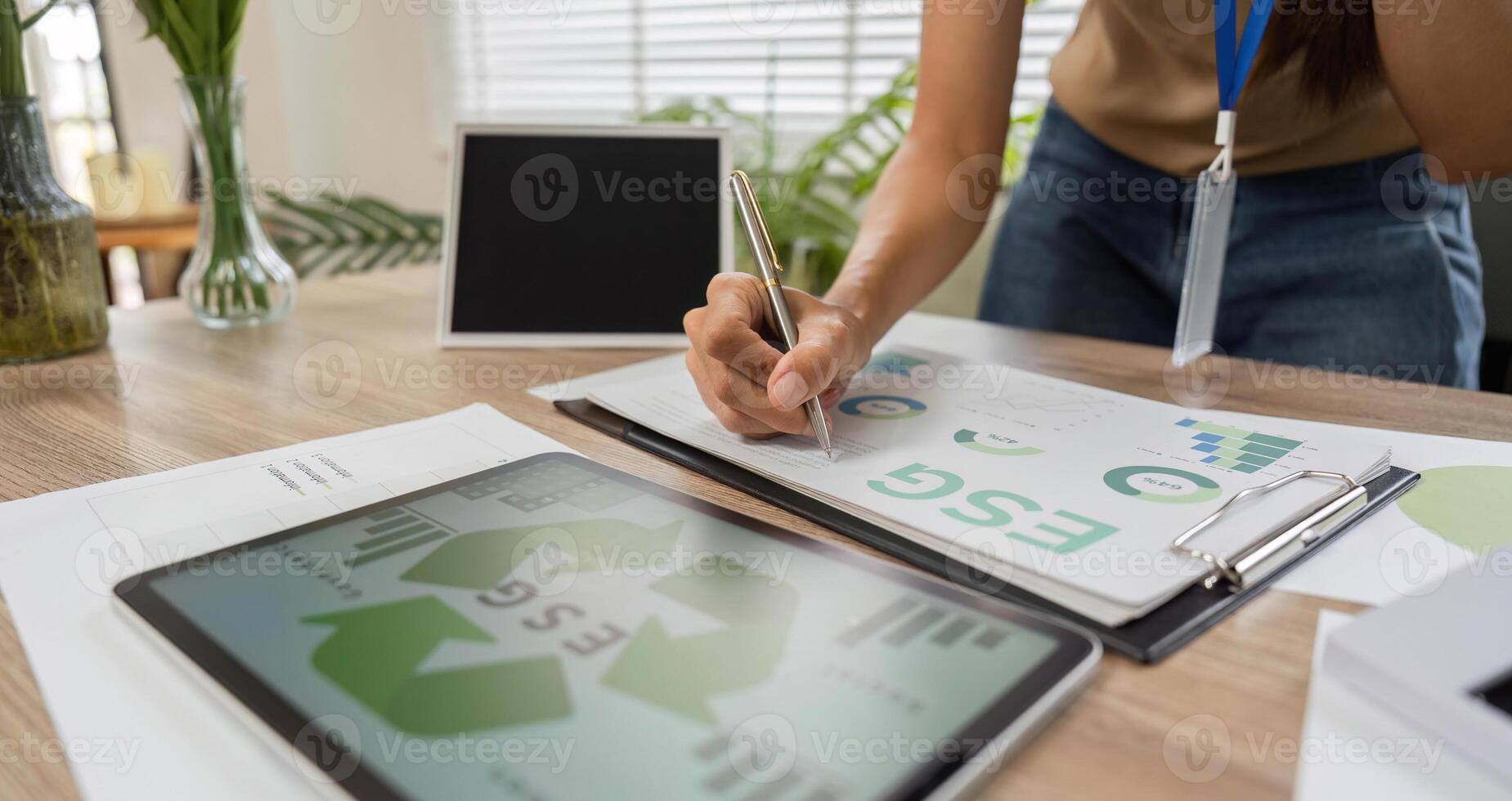 ESG sustainability planning with tablet and documents photo