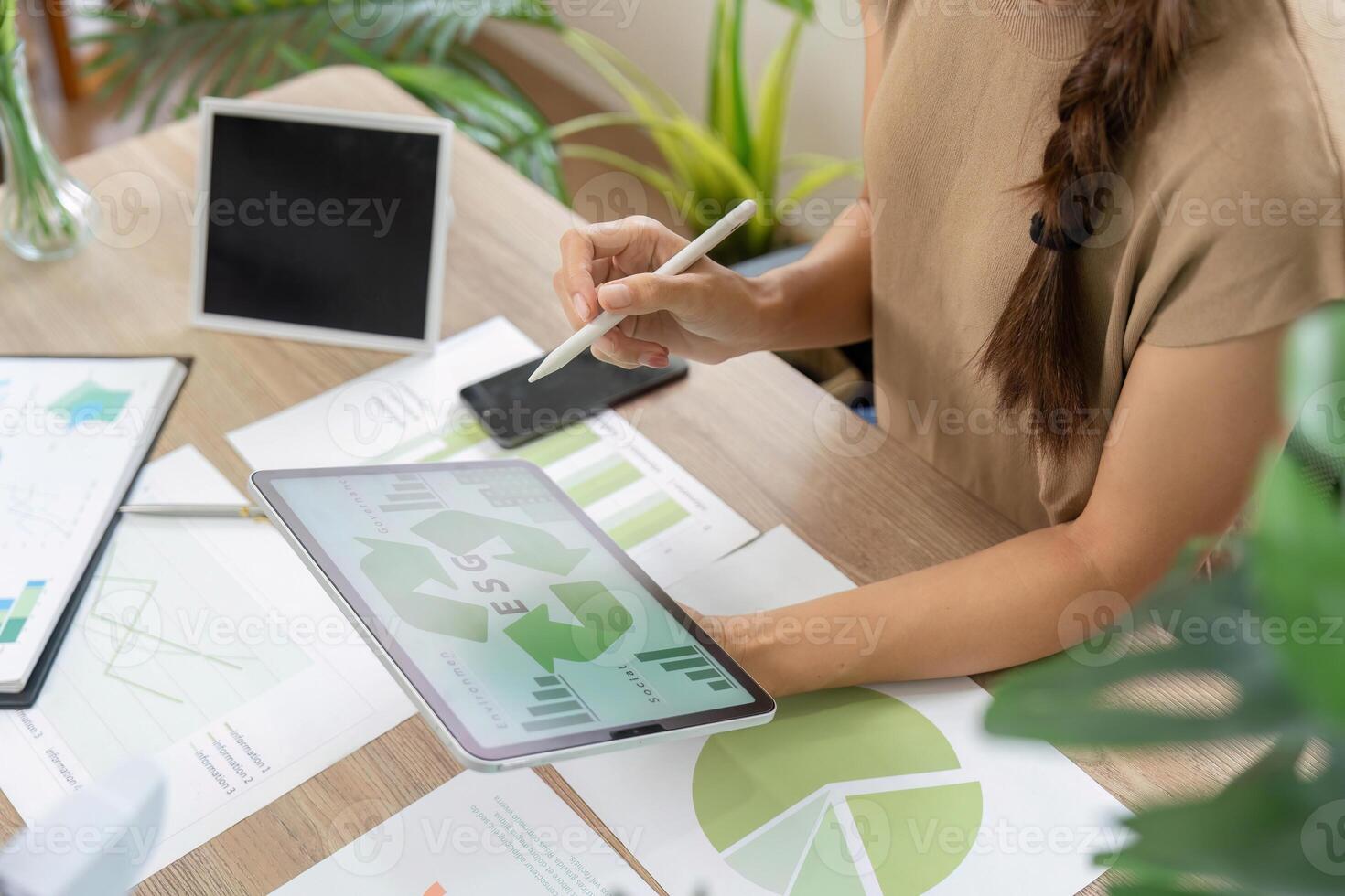 ESG sustainability analysis with graphs and charts on tablet photo