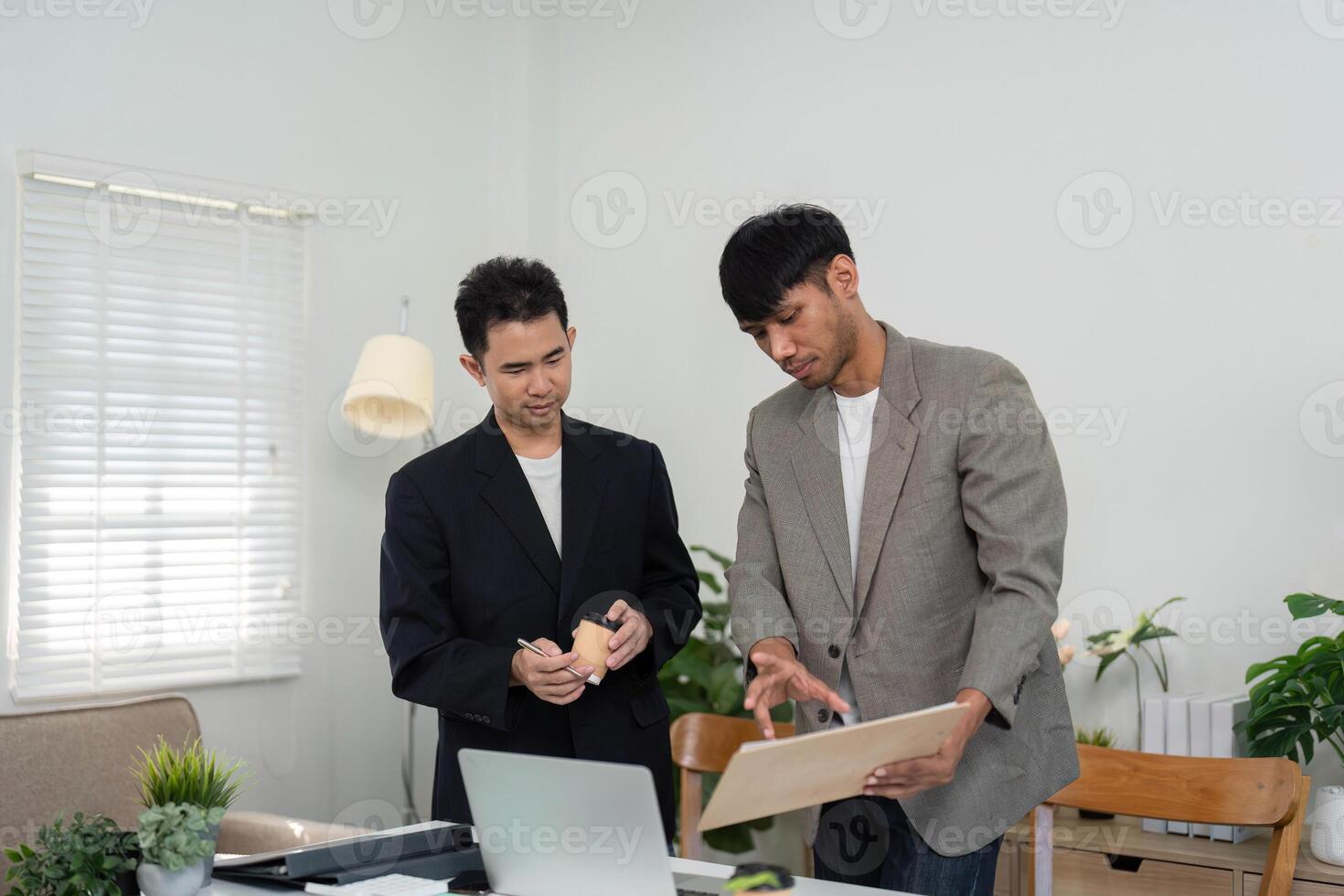 Engaging Business Conversation and Collaboration. Two professionals discussing ideas and strategies in a bright office setting. photo