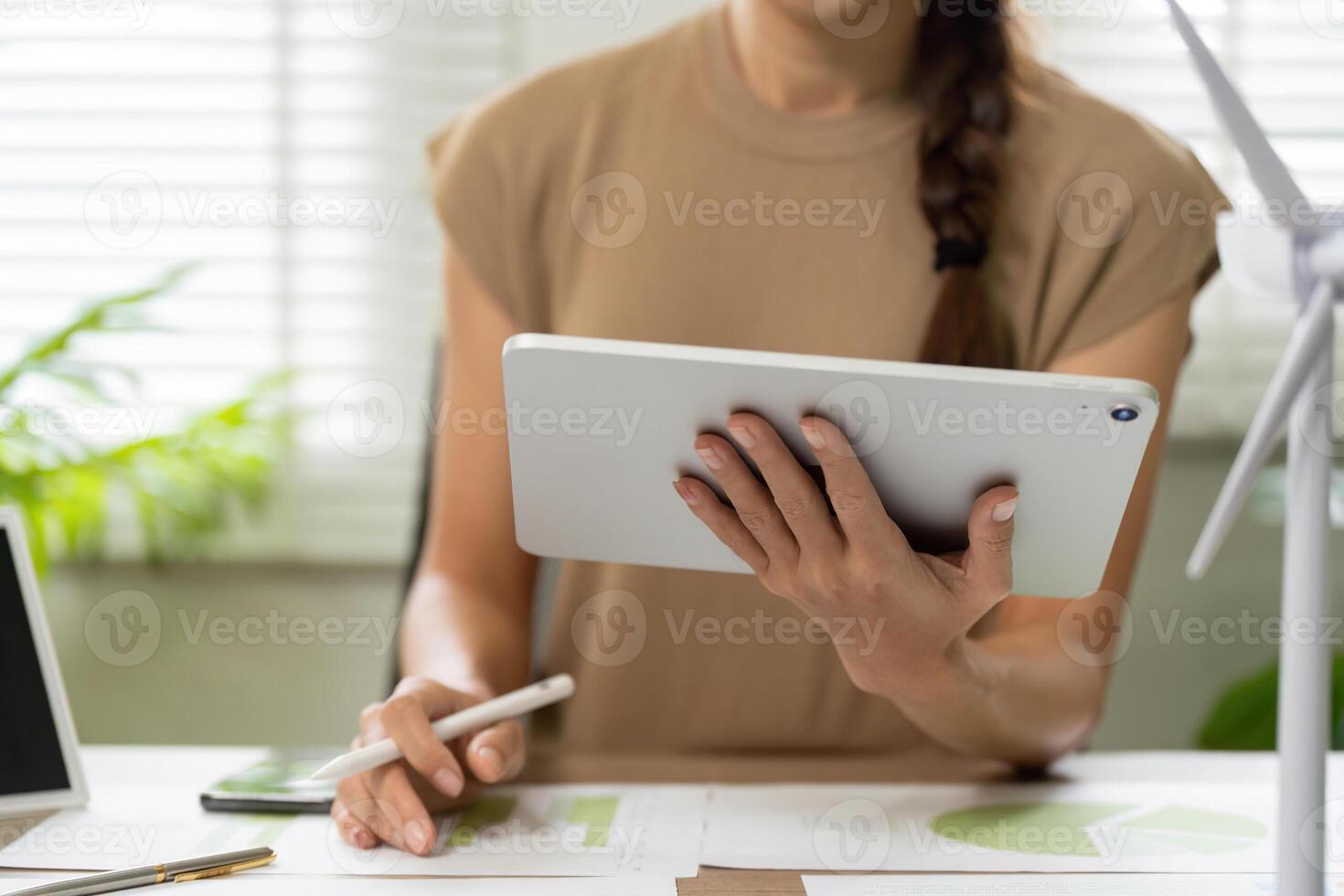 ESG sustainability insights with tablet and wind turbine model photo
