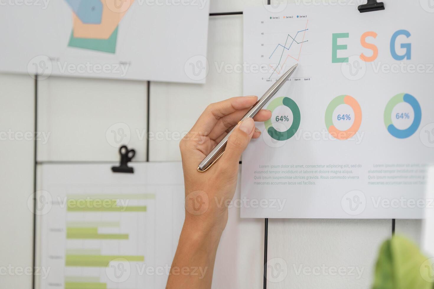 ESG analysis featuring hand pointing at sustainable metrics on wall photo