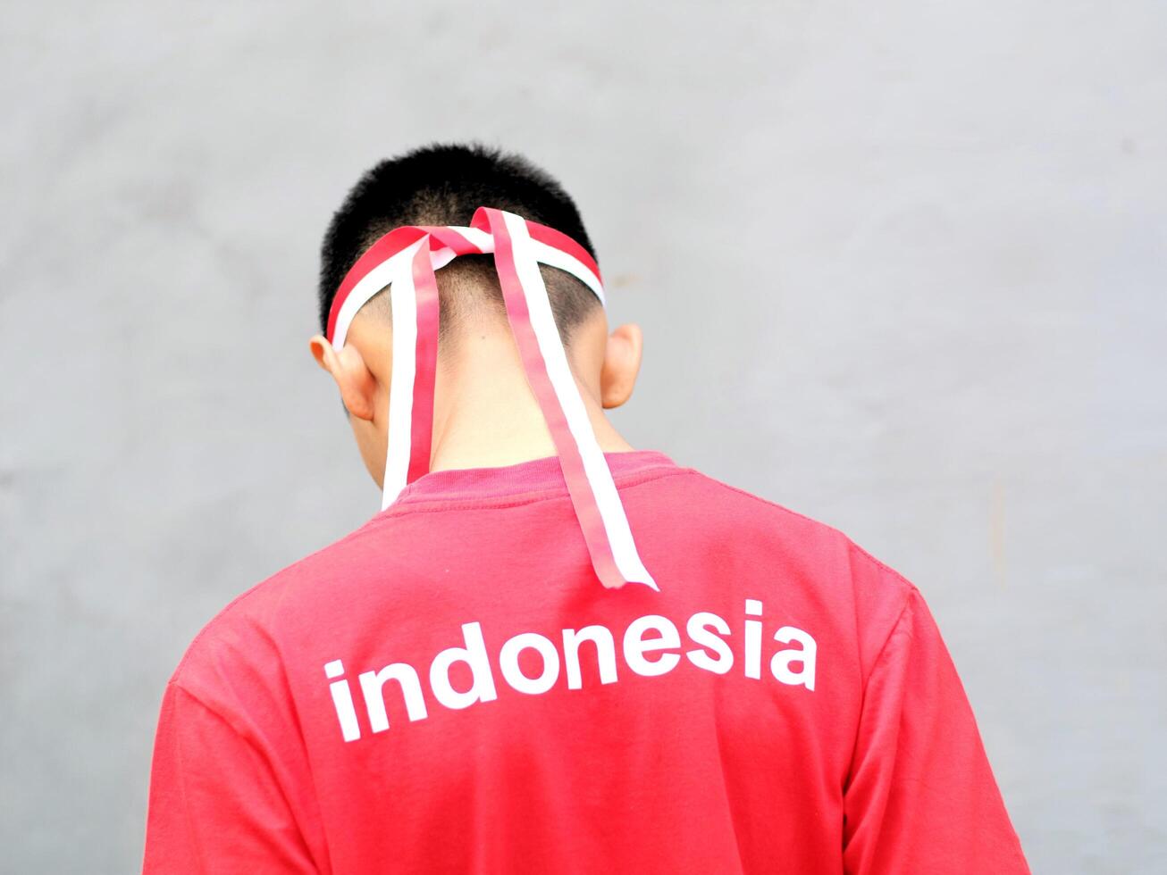 Indonesia boy wearing red white headband against grey background photo